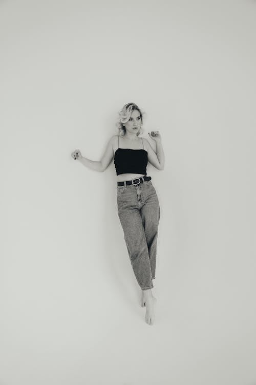 Young Blonde Woman Posing in Black Strapped Top and Jeans