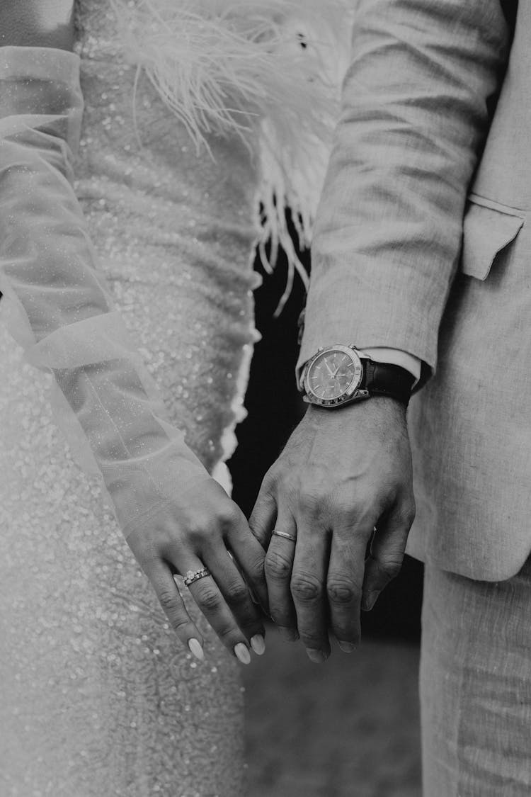 Newlywed Couple Touching Hands