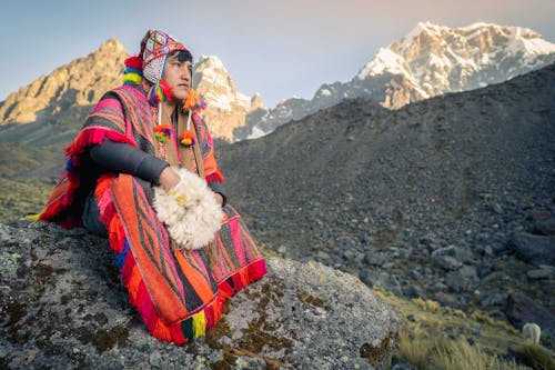 Man Wearing Traditional Clothes in Mountains