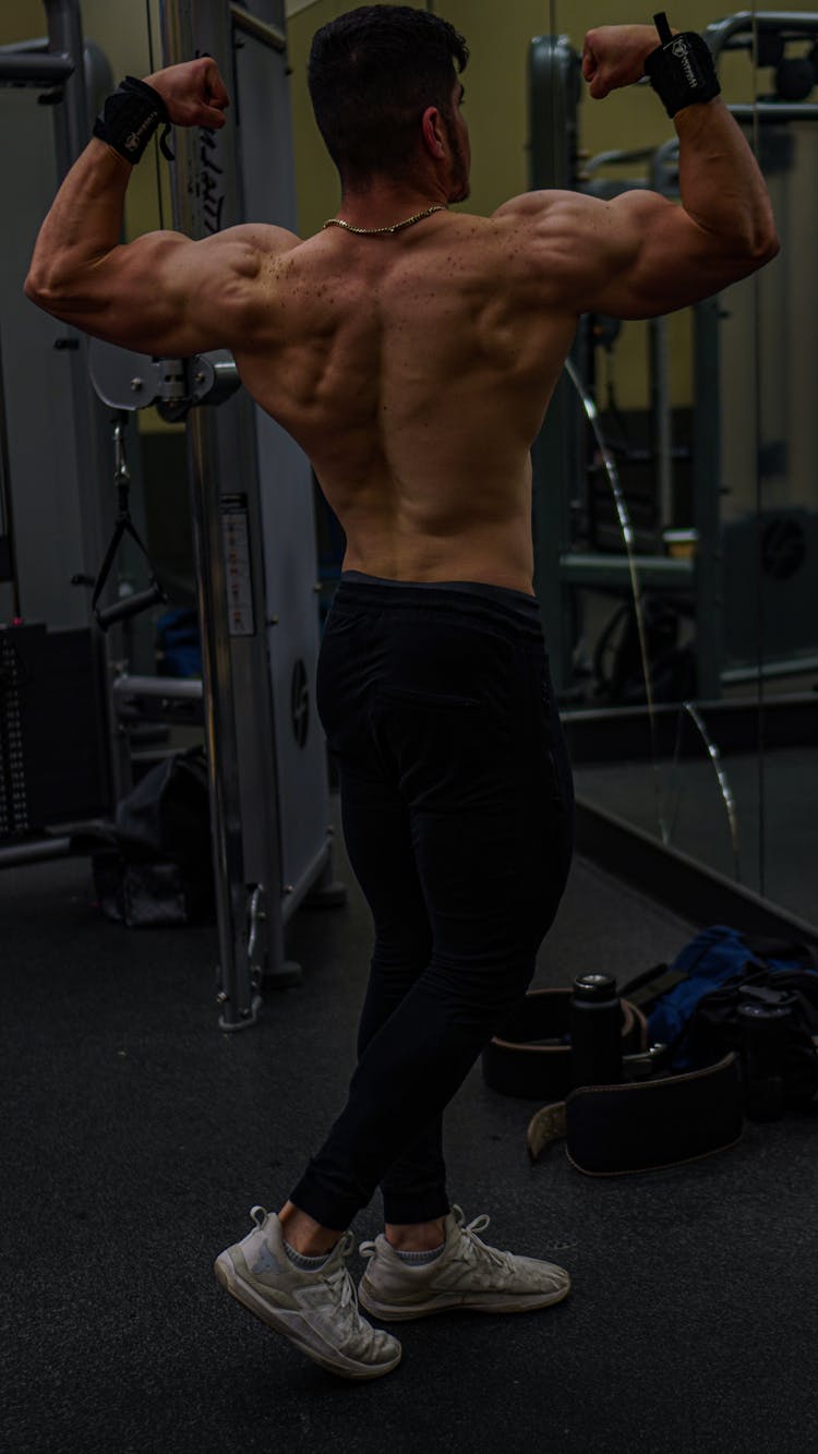 Back View Of A Muscular Man Exercising In A Gym