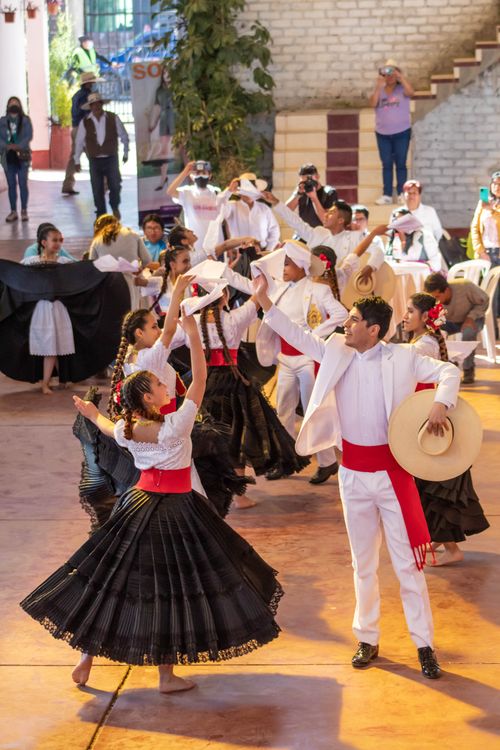 Free Vibrant traditional dance performance with dancers in colorful costumes at a cultural festival. Stock Photo