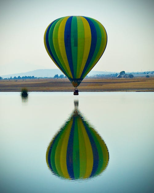 Multi Colored Hot Air Balloon over Lake