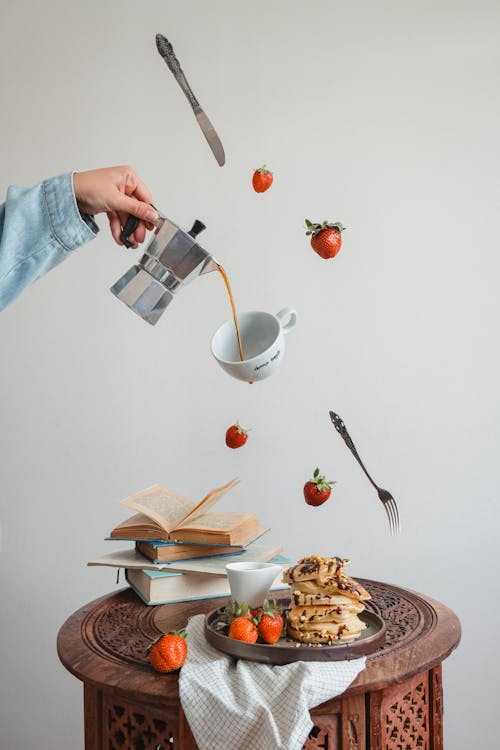 Free Hand Pouring Coffee from Moka Pot to Cup Stock Photo