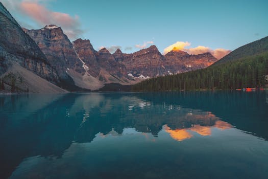 Breathtaking view of Moraine Lake reflecting rugged peaks at sunset in Banff National Park.