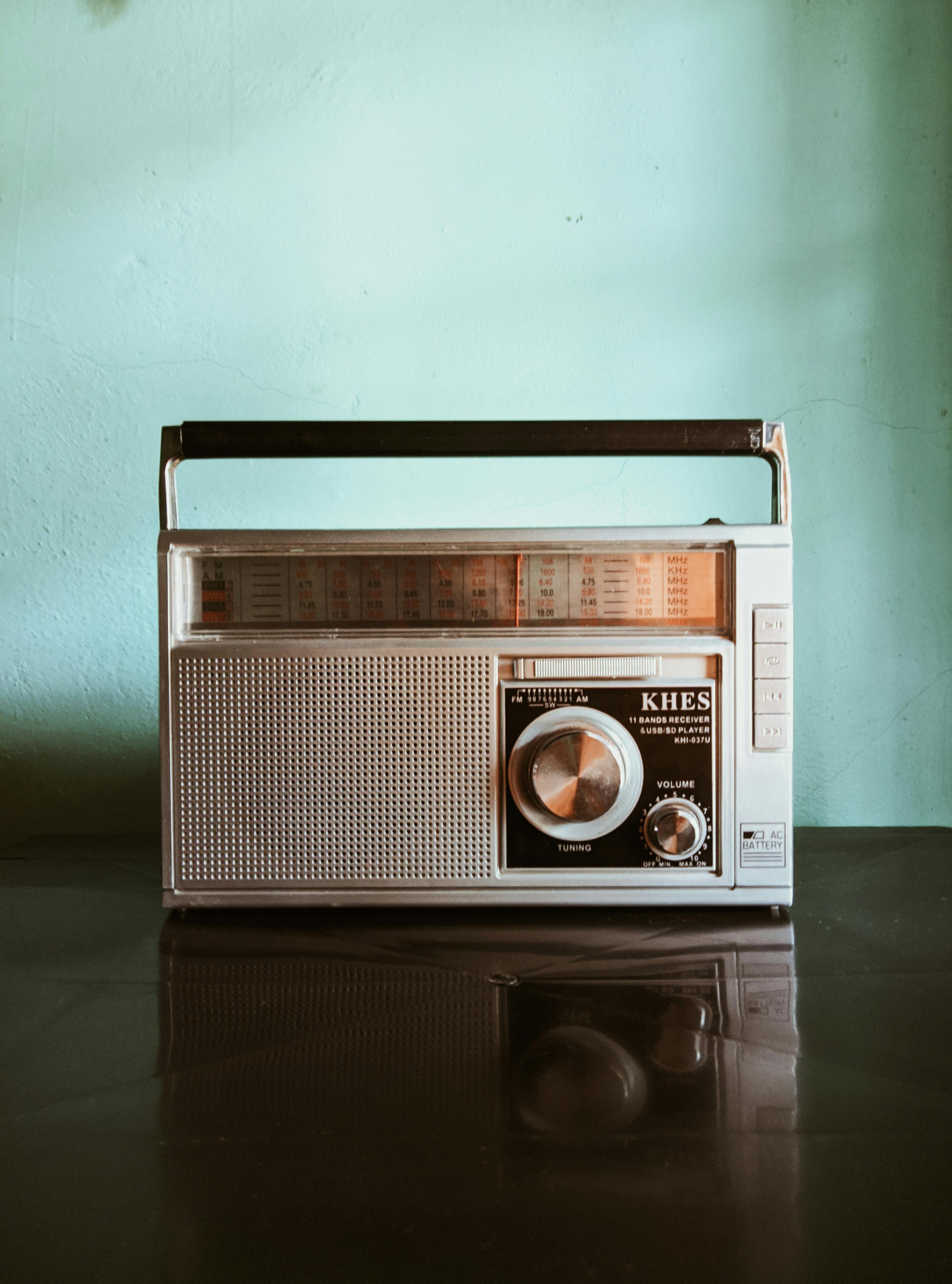 Retro transistor radio with knobs and grid design, evoking nostalgia.