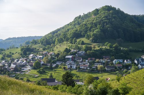 Free Beautiful village nestled at the lush green hillside during a serene spring day. Stock Photo