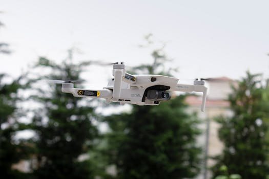 High-quality image of a drone in flight with blurred trees in the background, emphasizing technology and outdoor activities.