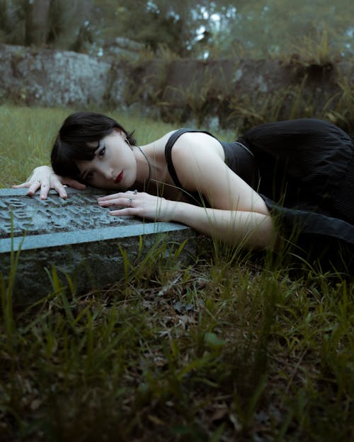 A Young Woman Lying on a Gravestone