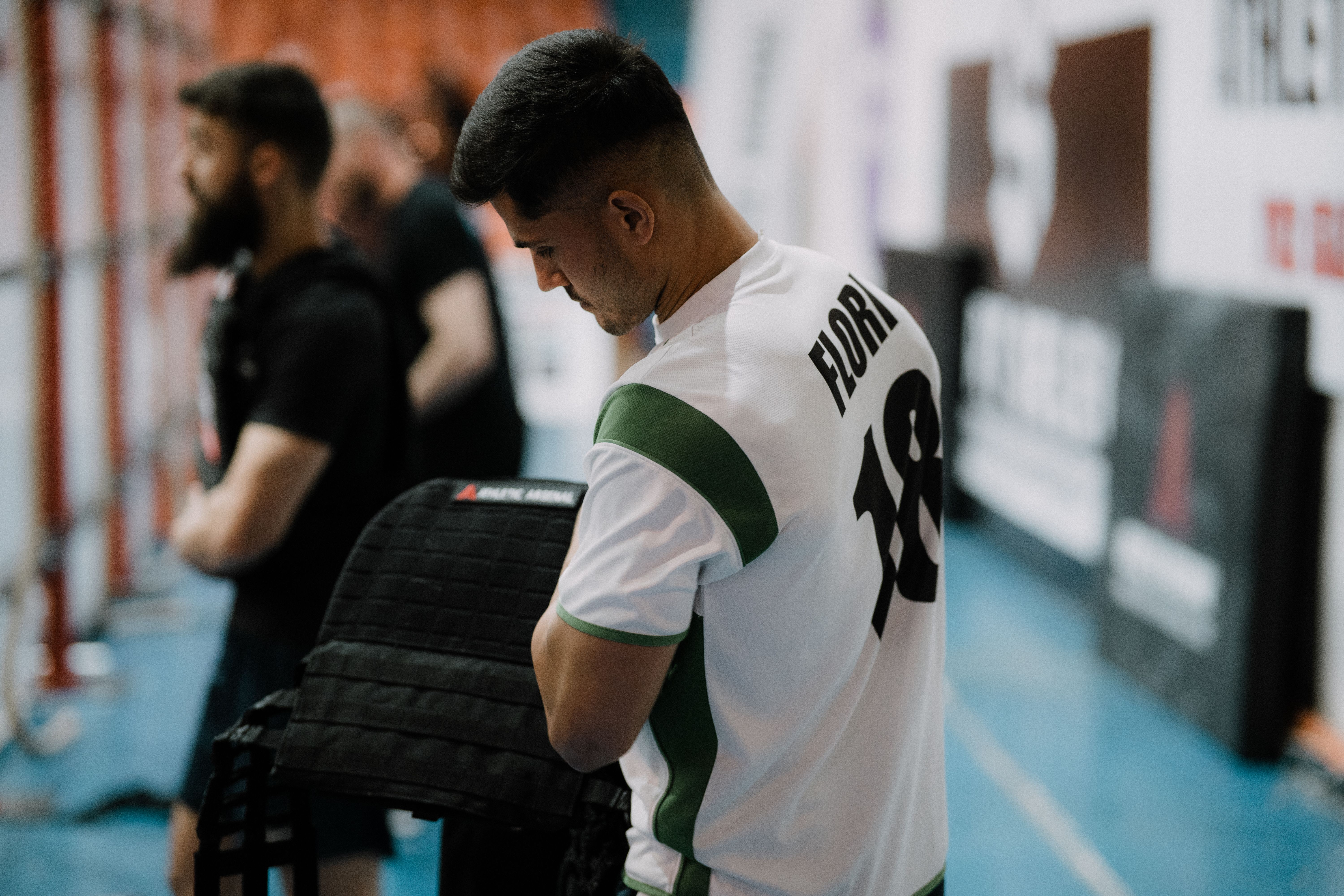 A focused athlete in sportswear prepares for an event indoors. Suitable for sports and lifestyle themes.