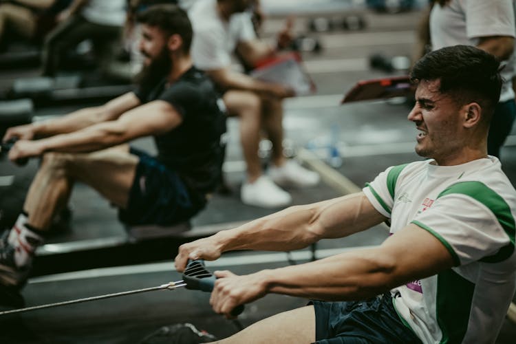 Men Rowing At Gym