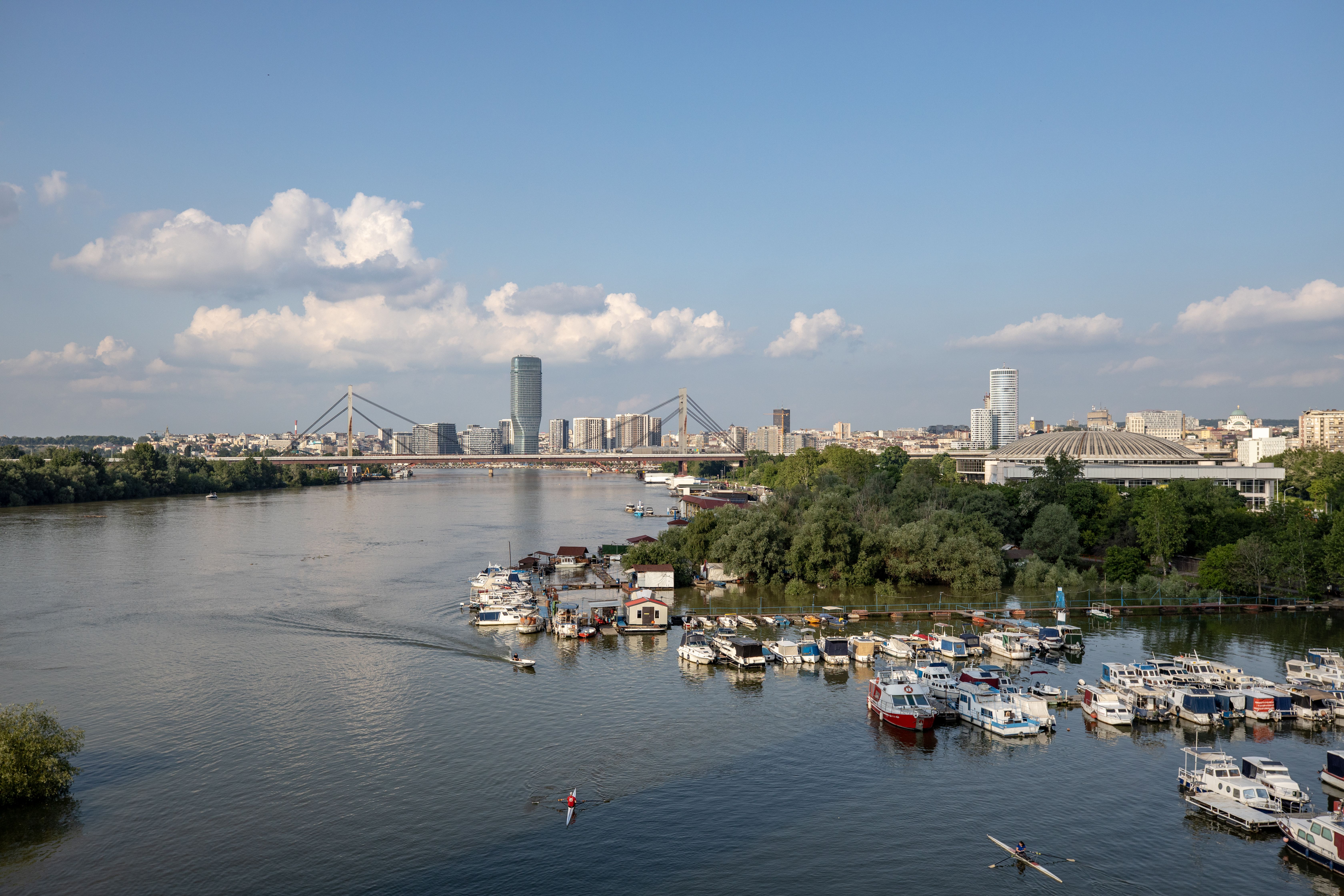 A stunning view of Belgrade's marina with boats on a summer day, capturing the city's skyline and river.