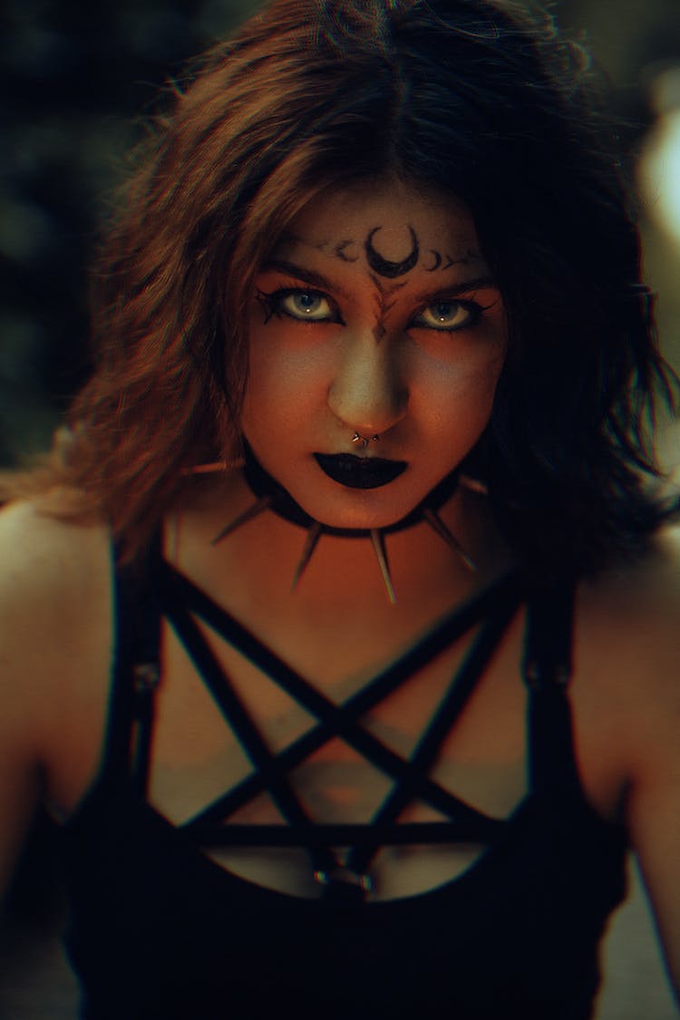 Portrait Pf Woman Wearing Pentagram Neckline Shirt And Black Lipstick 