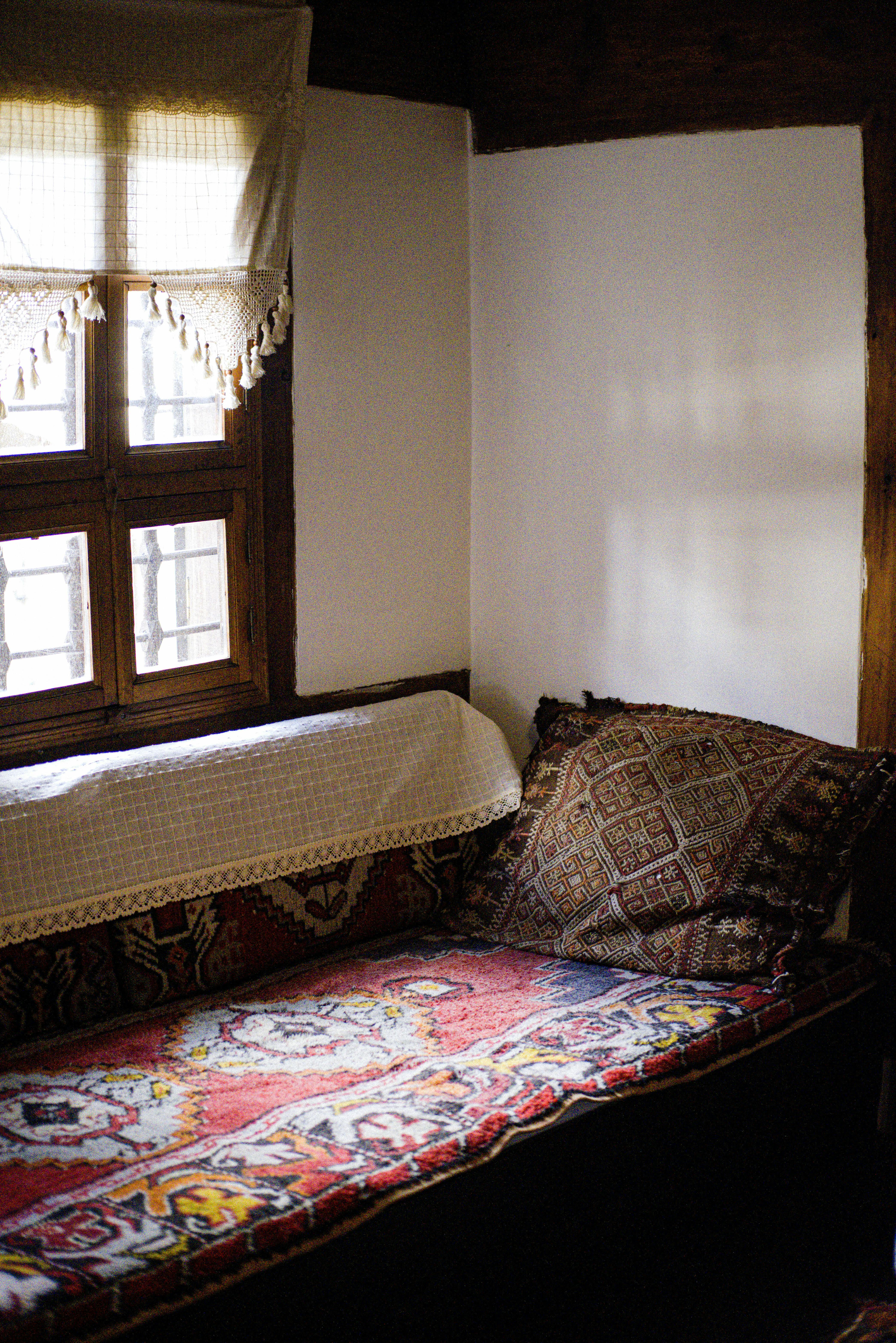 Warm vintage room with traditional patterns and rustic window lighting.