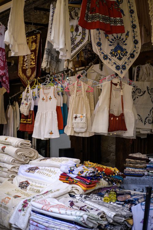 Free Colorful traditional dresses and fabrics hanging at a street market, showcasing cultural fashion. Stock Photo