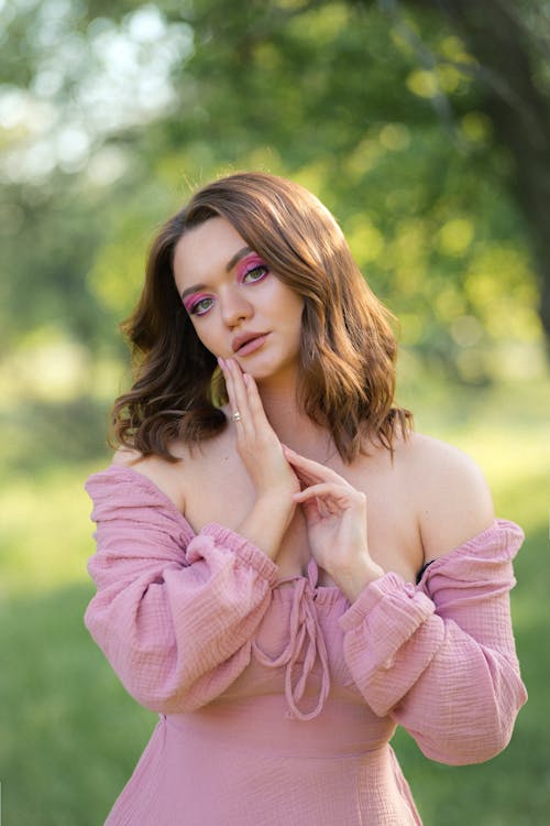 Young Woman in a Pink Dress Posing in the Garden