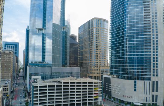 An aerial view of contemporary skyscrapers in downtown Houston, TX, showcasing modern architectural design.