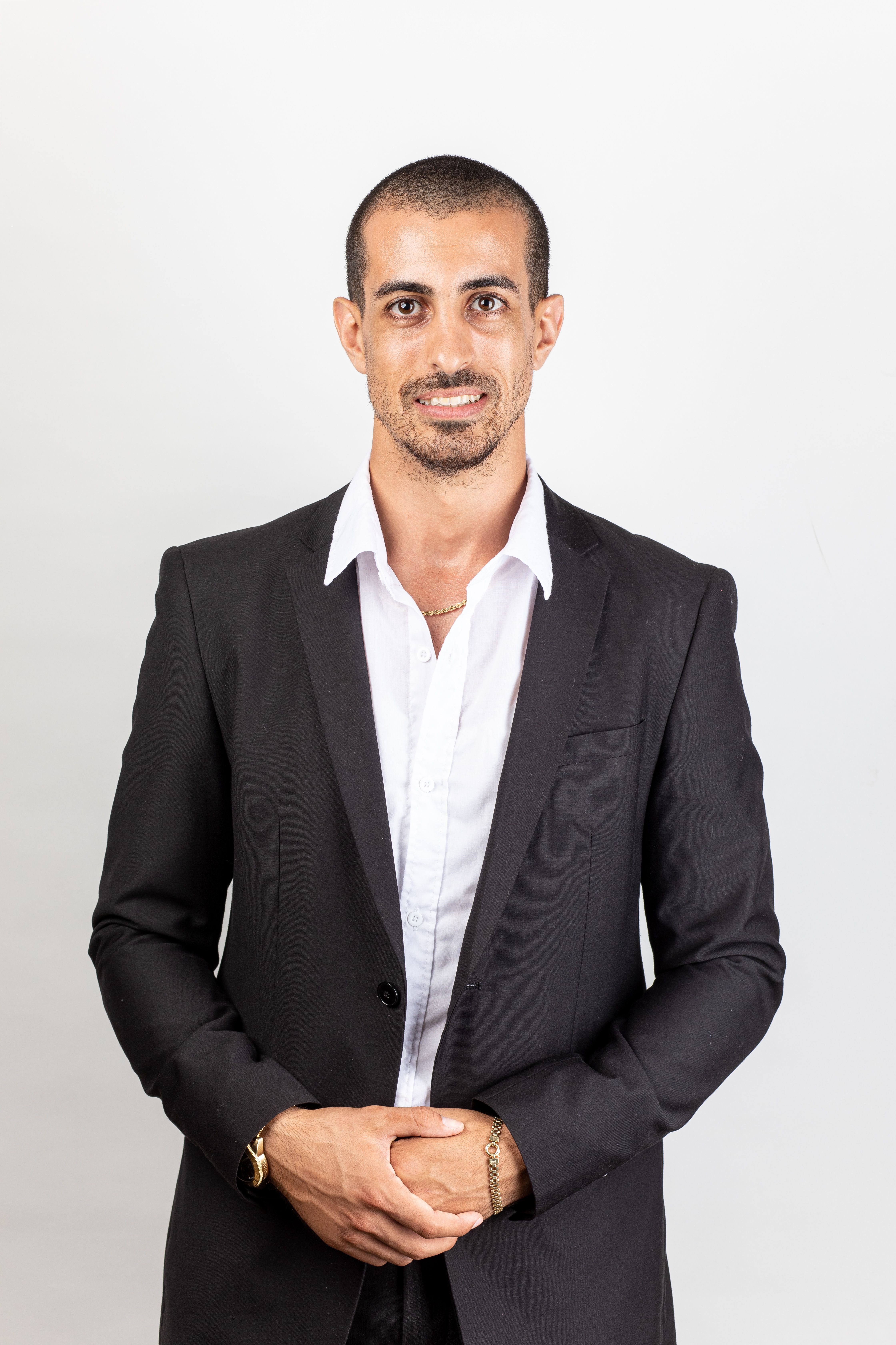 Studio portrait of a confident man in a business suit posing against a white background.