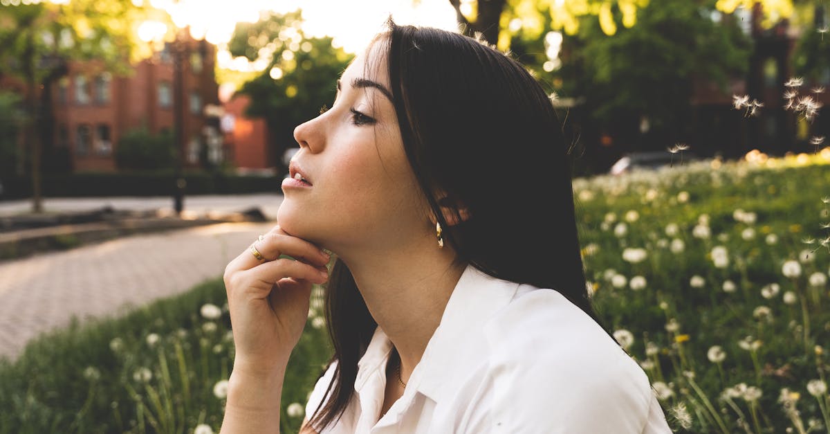 A woman sitting on the grass in a field