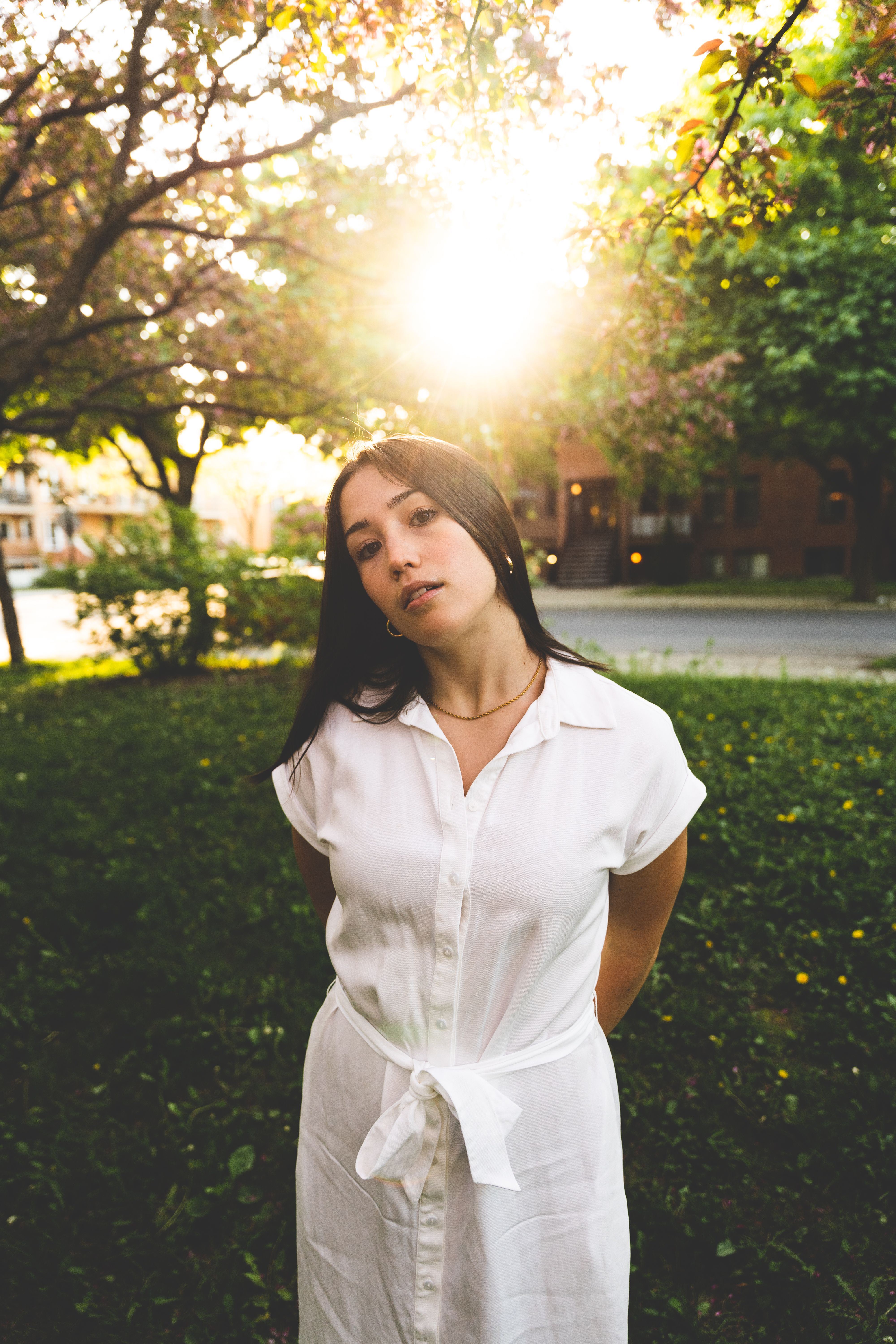A woman in a white dress standing in the sun · Free Stock Photo