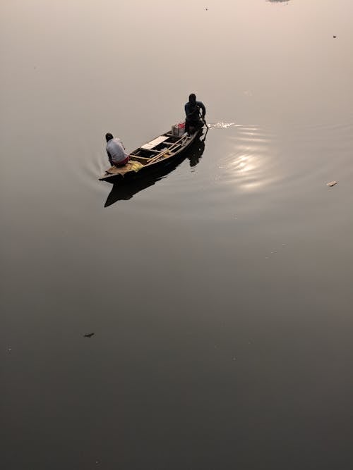 Free Two People Riding on Canoe during Daytime Stock Photo