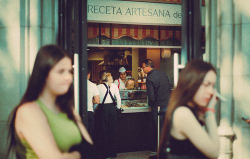 Free People gather at a bakery, showcasing bustling city life and morning rituals. Stock Photo