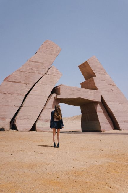 A woman stands in front of a striking rock formation in Egypt's Ras Mohamed National Park.