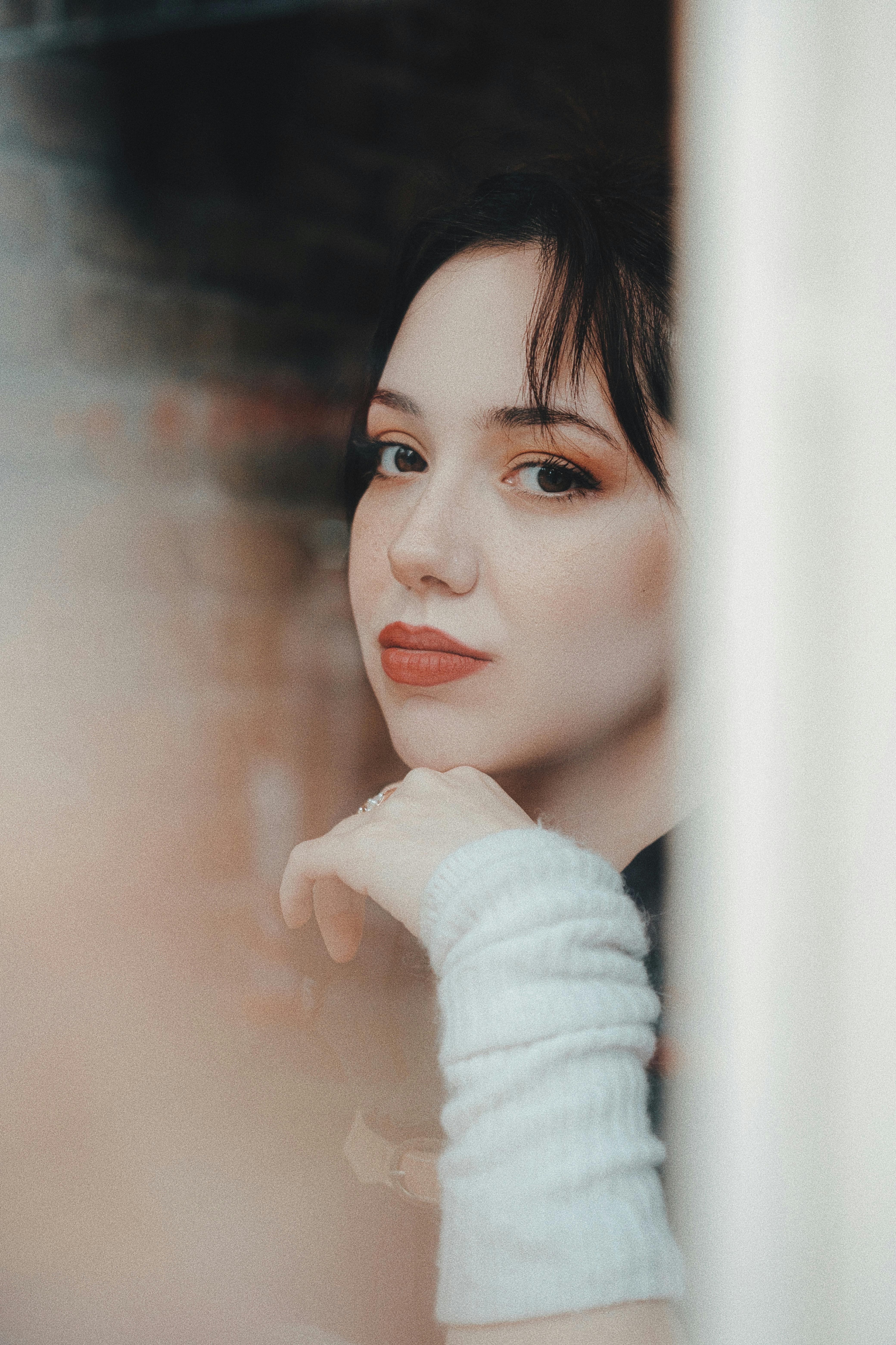 Picture of a Young Woman taken from behind a Window · Free Stock Photo