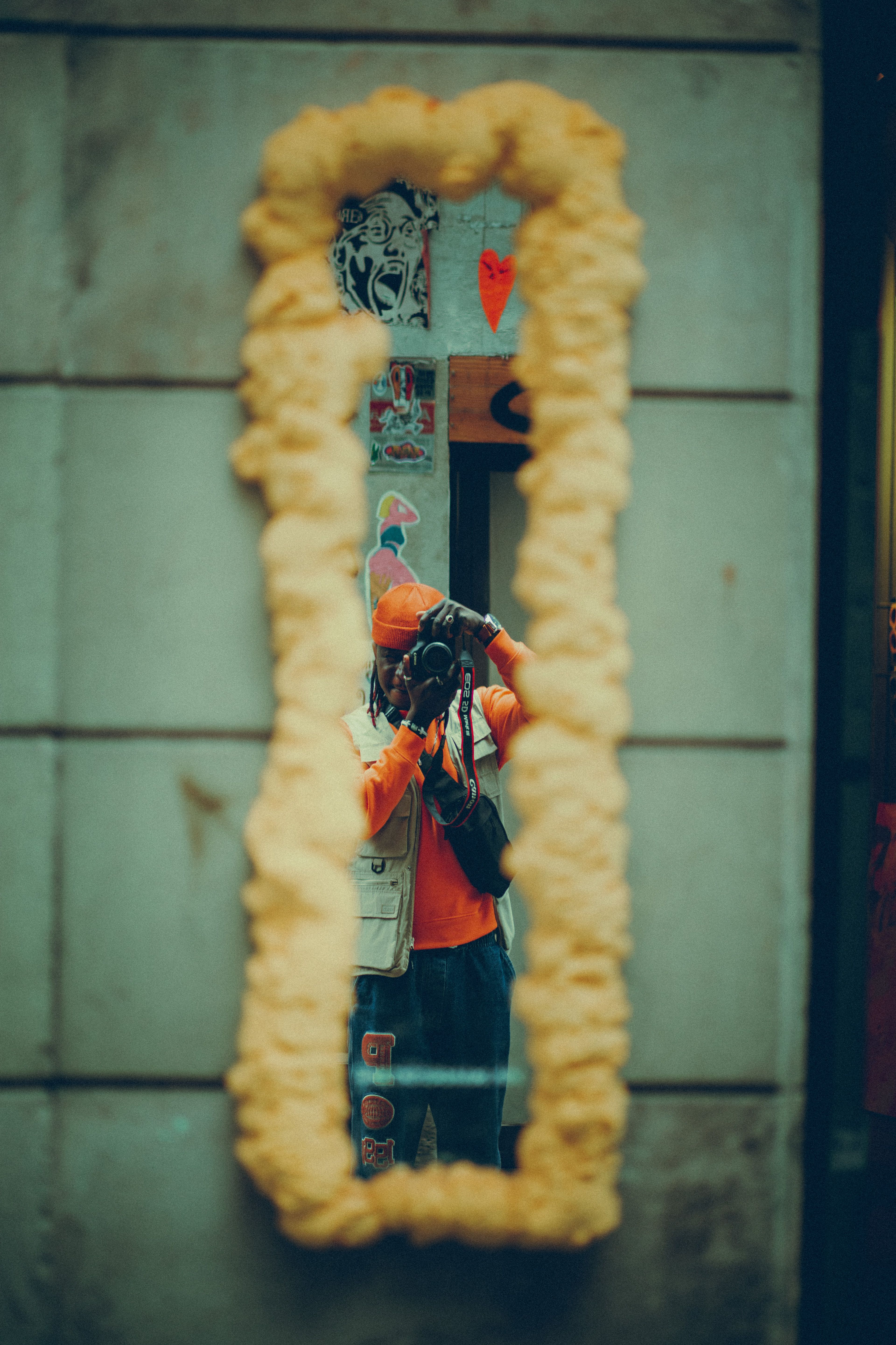 Photographer captures urban style reflected in a creatively framed mirror.