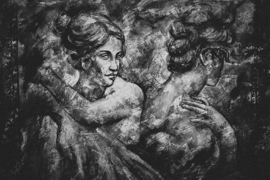 An artistic depiction of two zodiac symbols, Aries and Leo, interacting in a warm, glowing cosmic dance