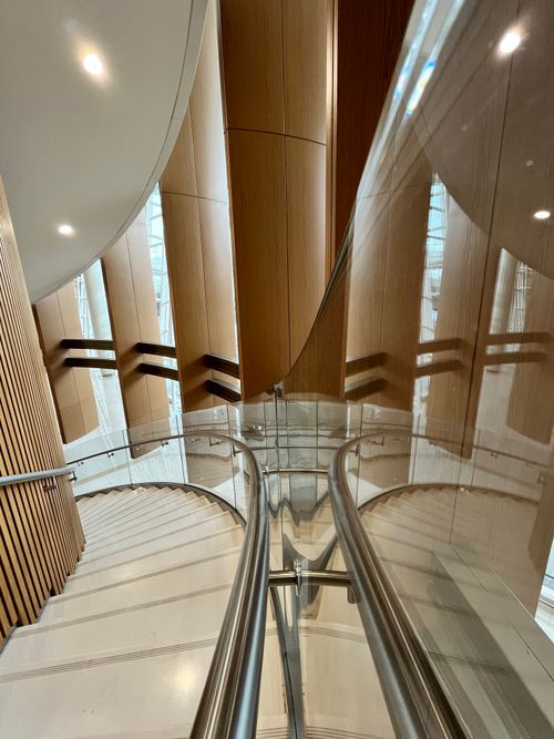 Free Stylish curved staircase with reflective handrails in a modern hotel in Muharraq, Bahrain. Stock Photo