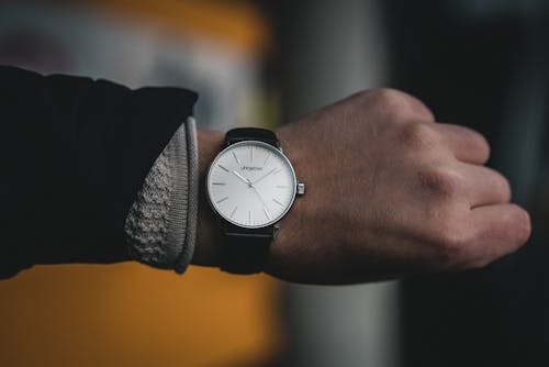 Free Person Wearing Round White Analog Watch at 10:09 Stock Photo