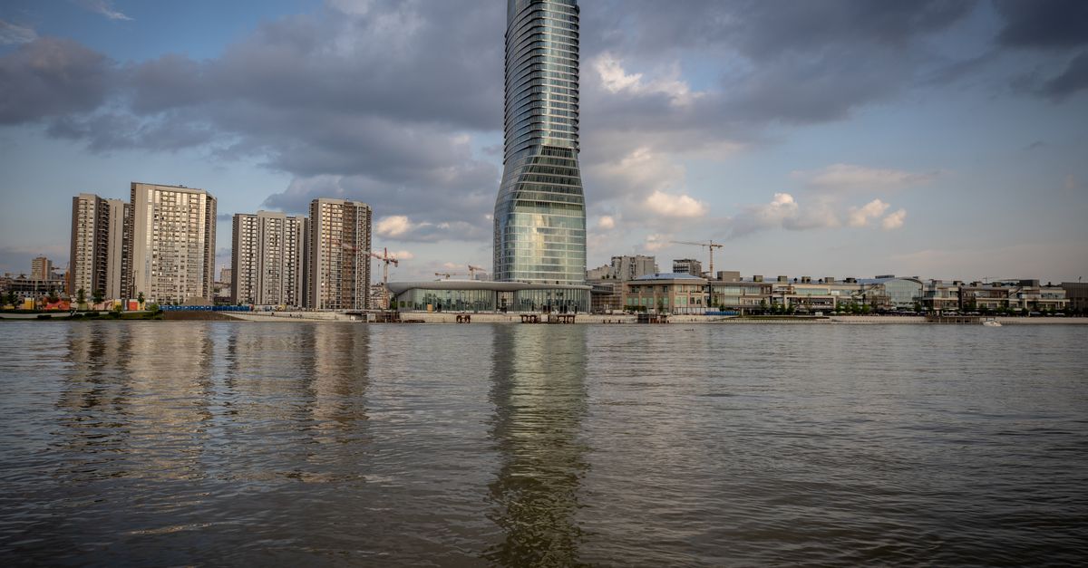 Contemporary skyscraper by a riverside creating a stunning urban skyline.