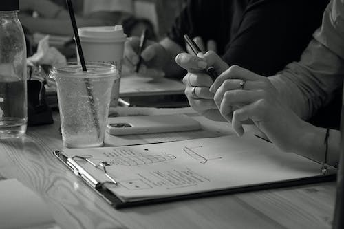 Close-up of Womans Hands on a Notepad 