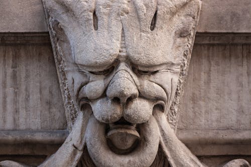 Close-up of a Statue Carved on a Wall of a Building 