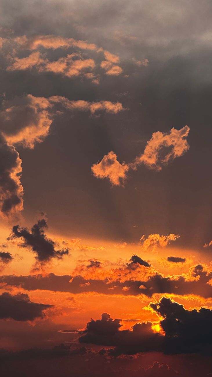 Stunning sunset with dramatic orange clouds in Romania, capturing the golden hour.