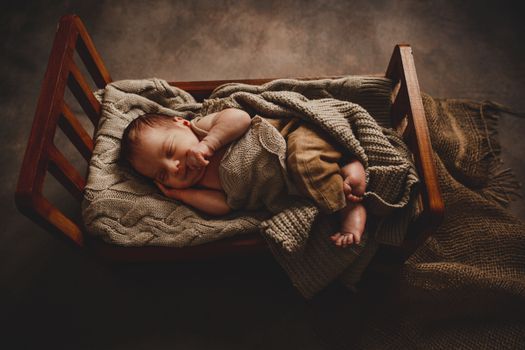 Newborn Sleeping in Wooden Bed