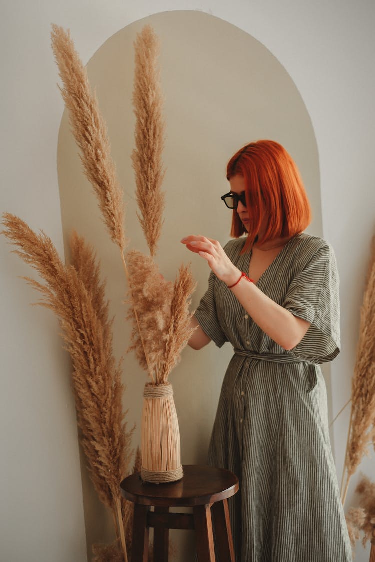 Red Haired Woman Arranging Dried Pampas Grass Decoration