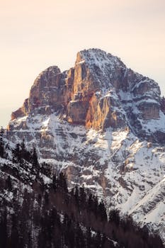 Stunning view of the snow-capped Dolomites during sunset showcasing natural beauty.