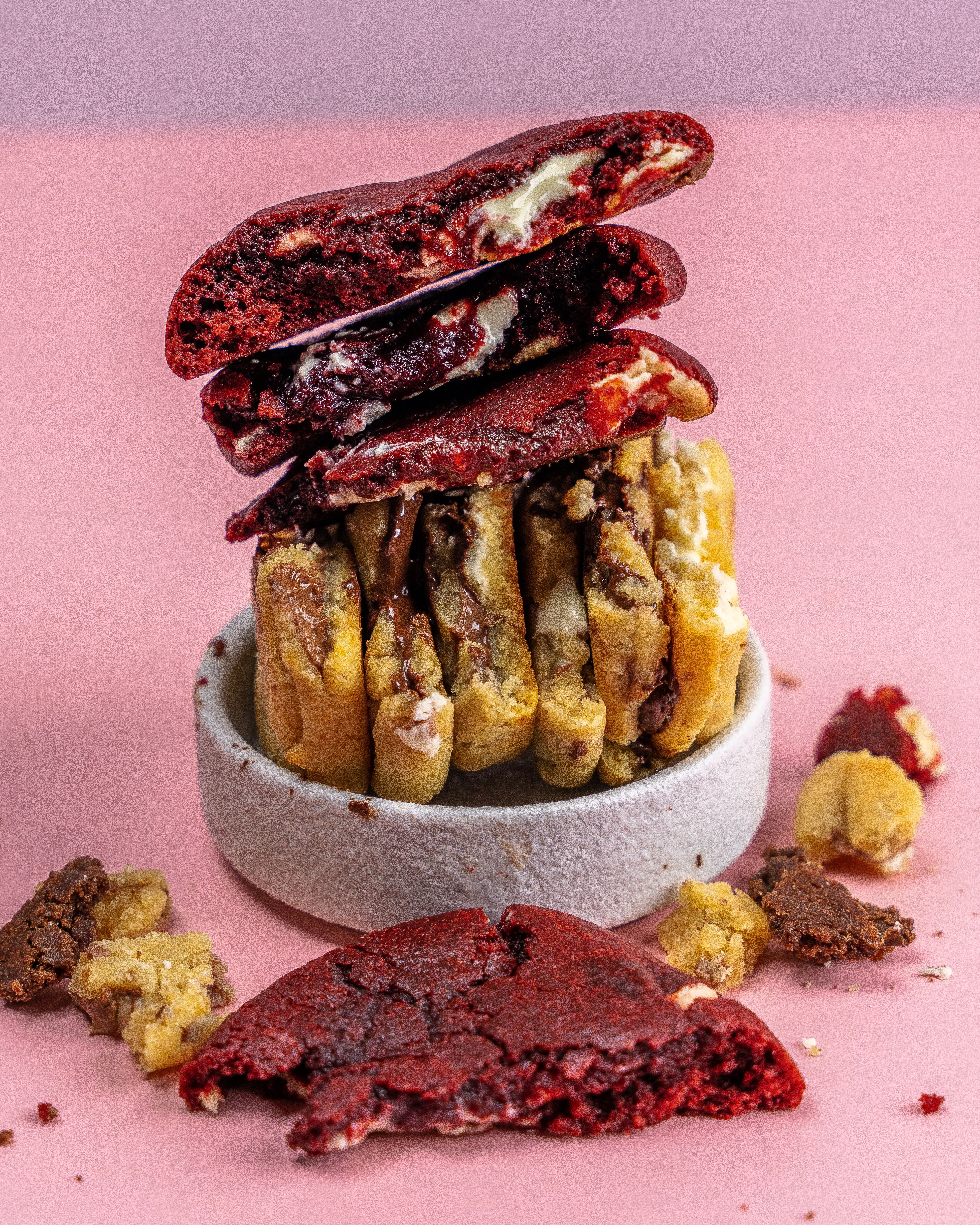 An assortment of chocolate chip and red velvet cookies in a bowl.