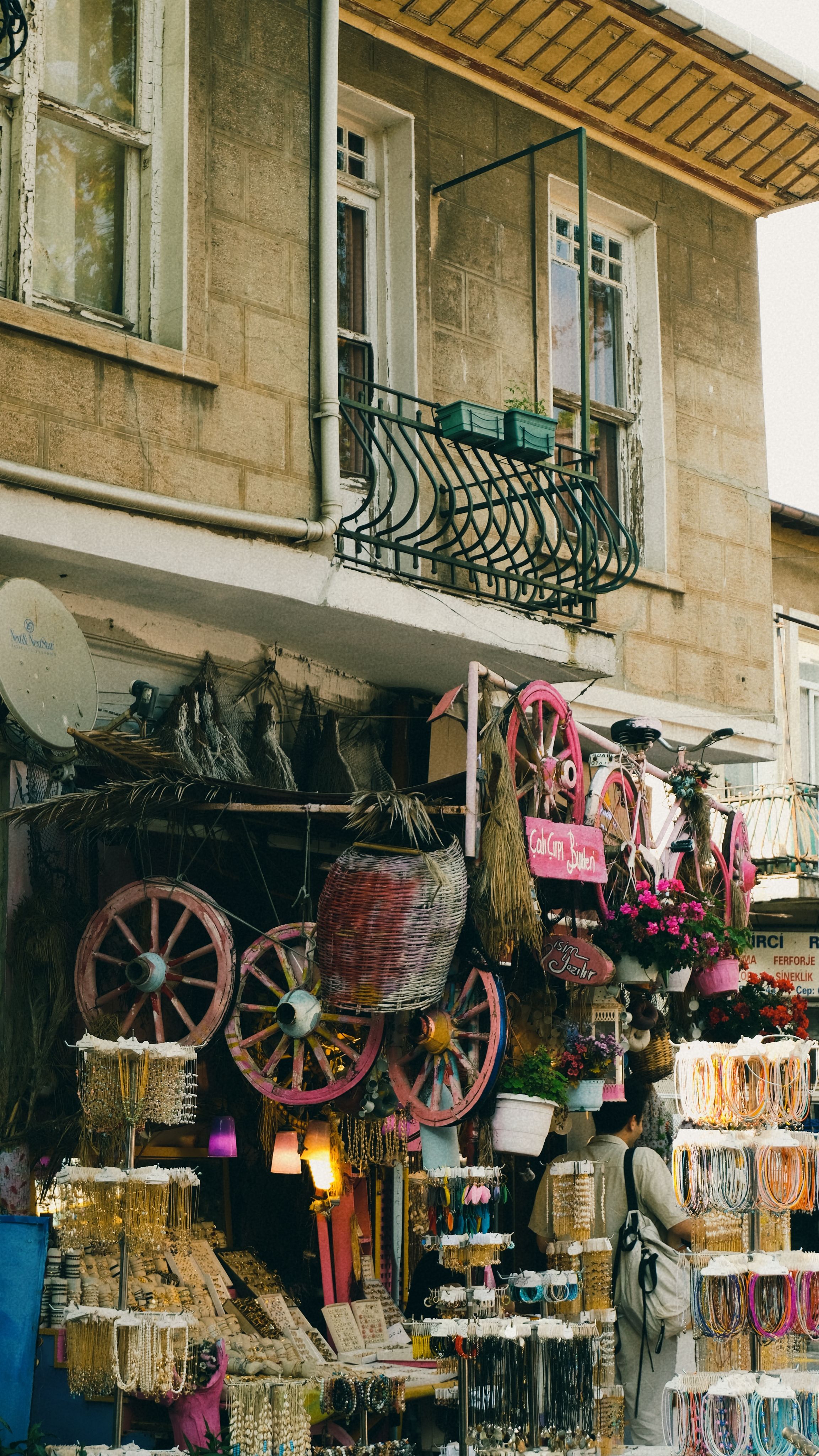Charming boutique shop with vibrant decor and unique merchandise on a rustic facade.