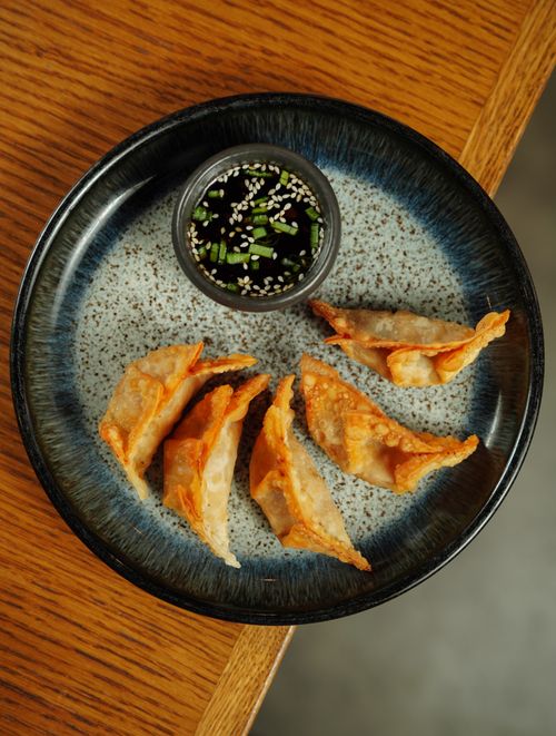 Free Delicious crispy dumplings served with soy dipping sauce on a ceramic plate. Stock Photo