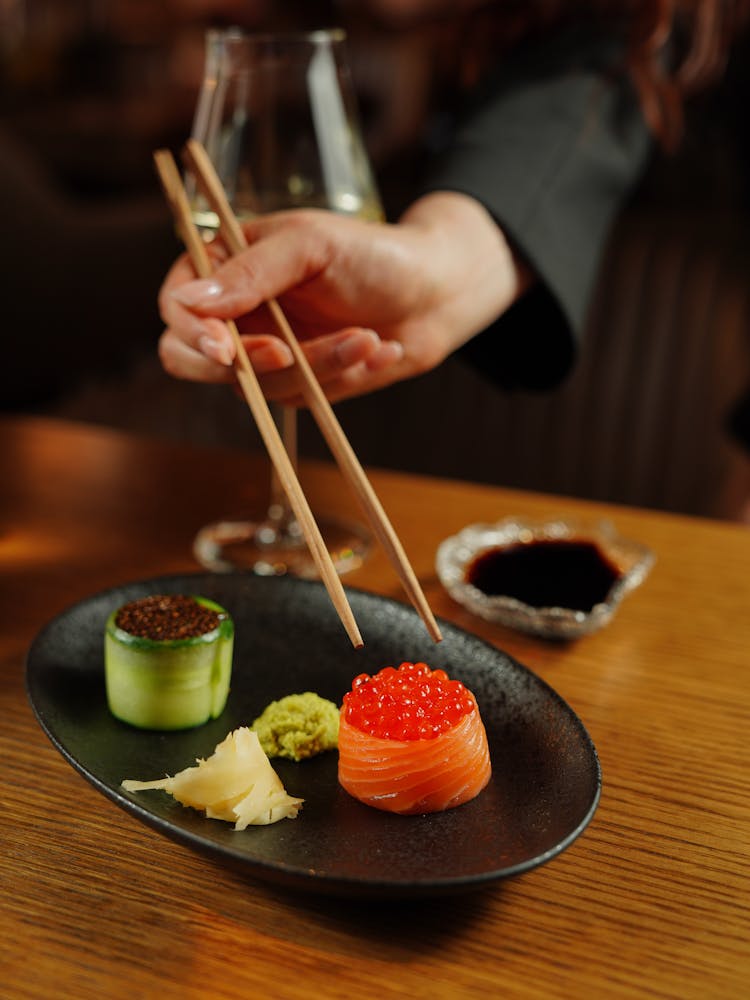 Woman Eating Seafood With Chopsticks