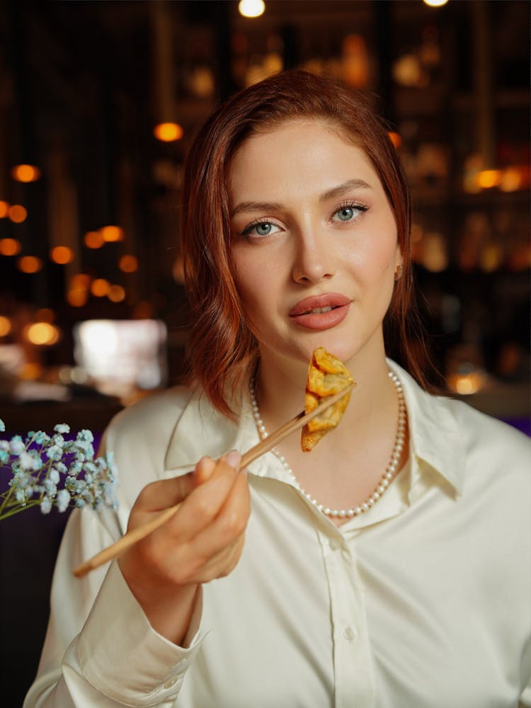 Woman Eating With Chopsticks