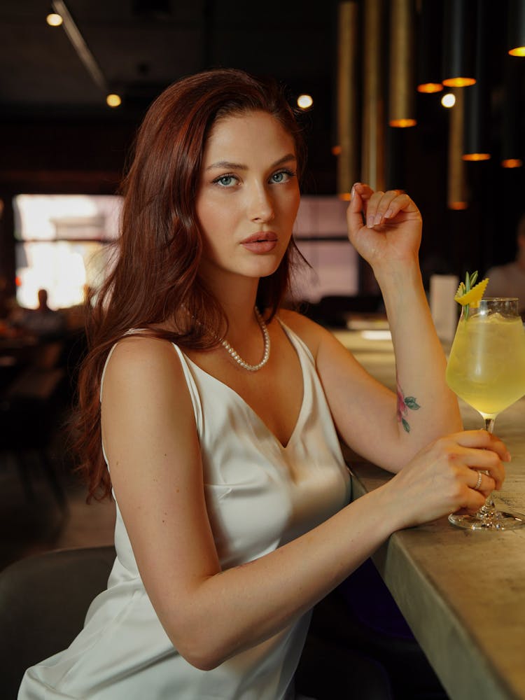 Woman Sitting At Bar Counter