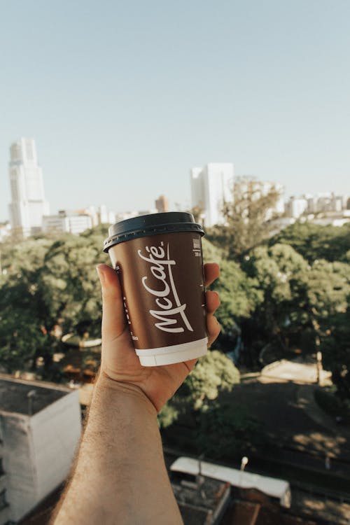 Free Person Holding a Brown Mccafe Coffee Cup Stock Photo