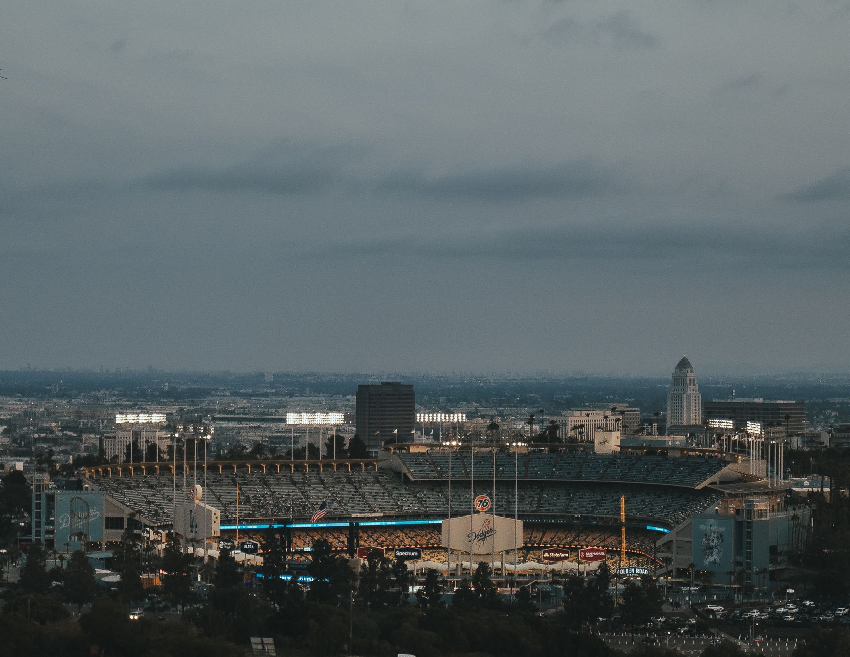 A stunning aerial view of Dodger Stadium in Los Angeles at dusk, showcasing the vibrant urban landscape.