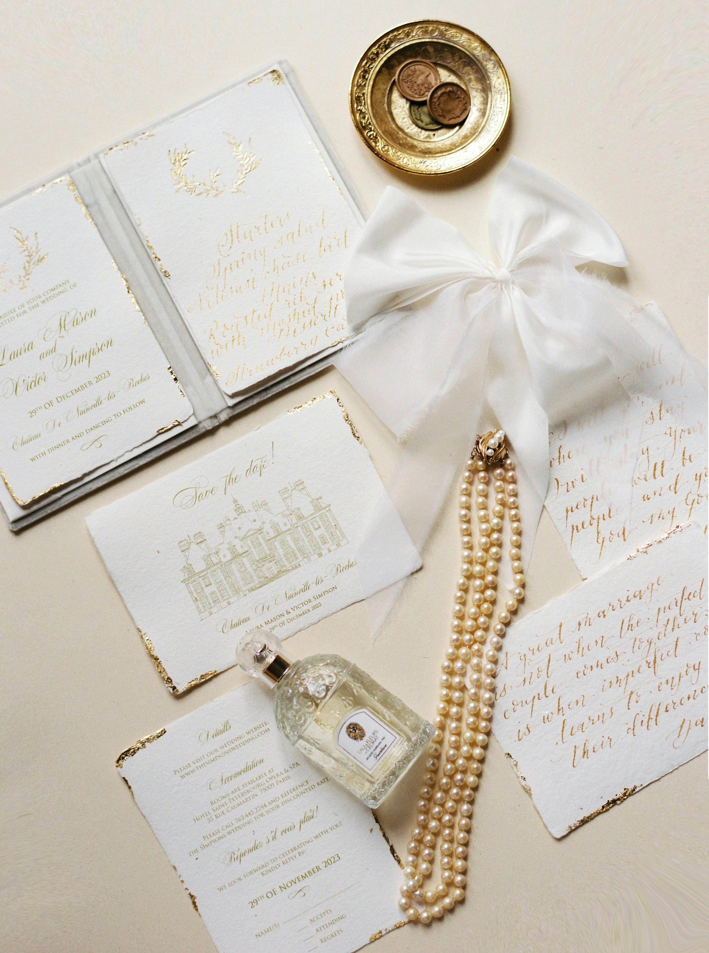 Chic flat lay of an elegant wedding set with pearls and perfume.