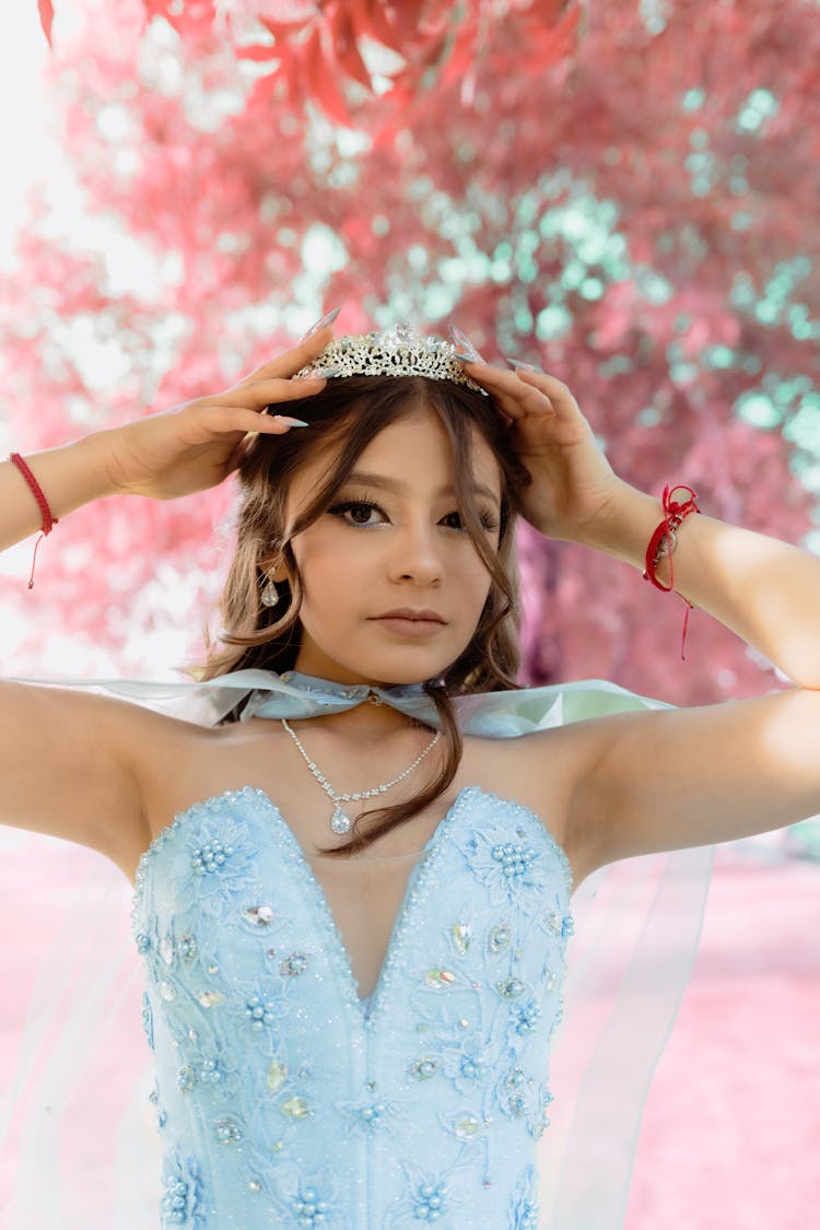 Young Woman In A Princess Dress And A Tiara Posing Outdoors 