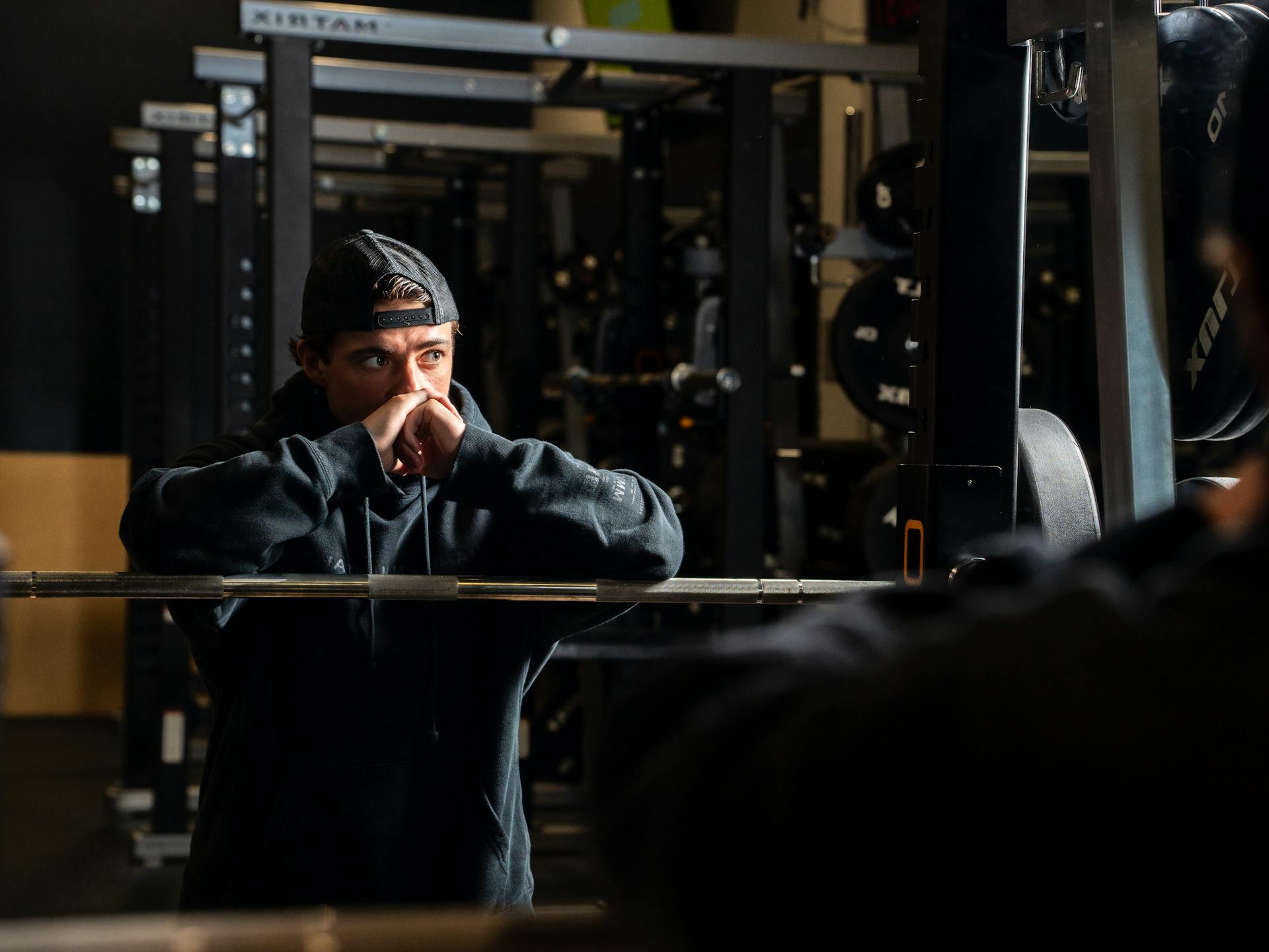 Man in Cap and Hoodie at Gym