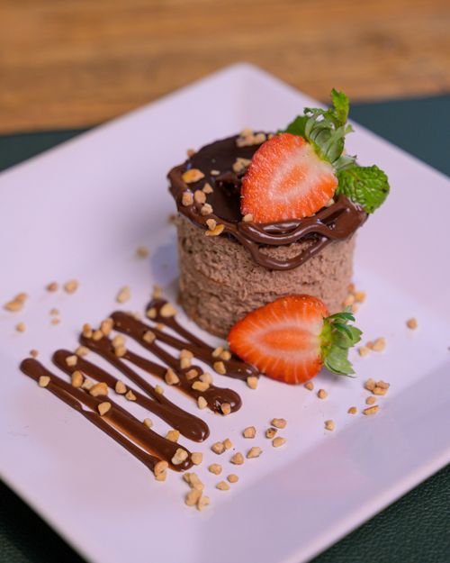 Free Indulge in a rich chocolate mousse topped with fresh strawberries and nuts. Stock Photo
